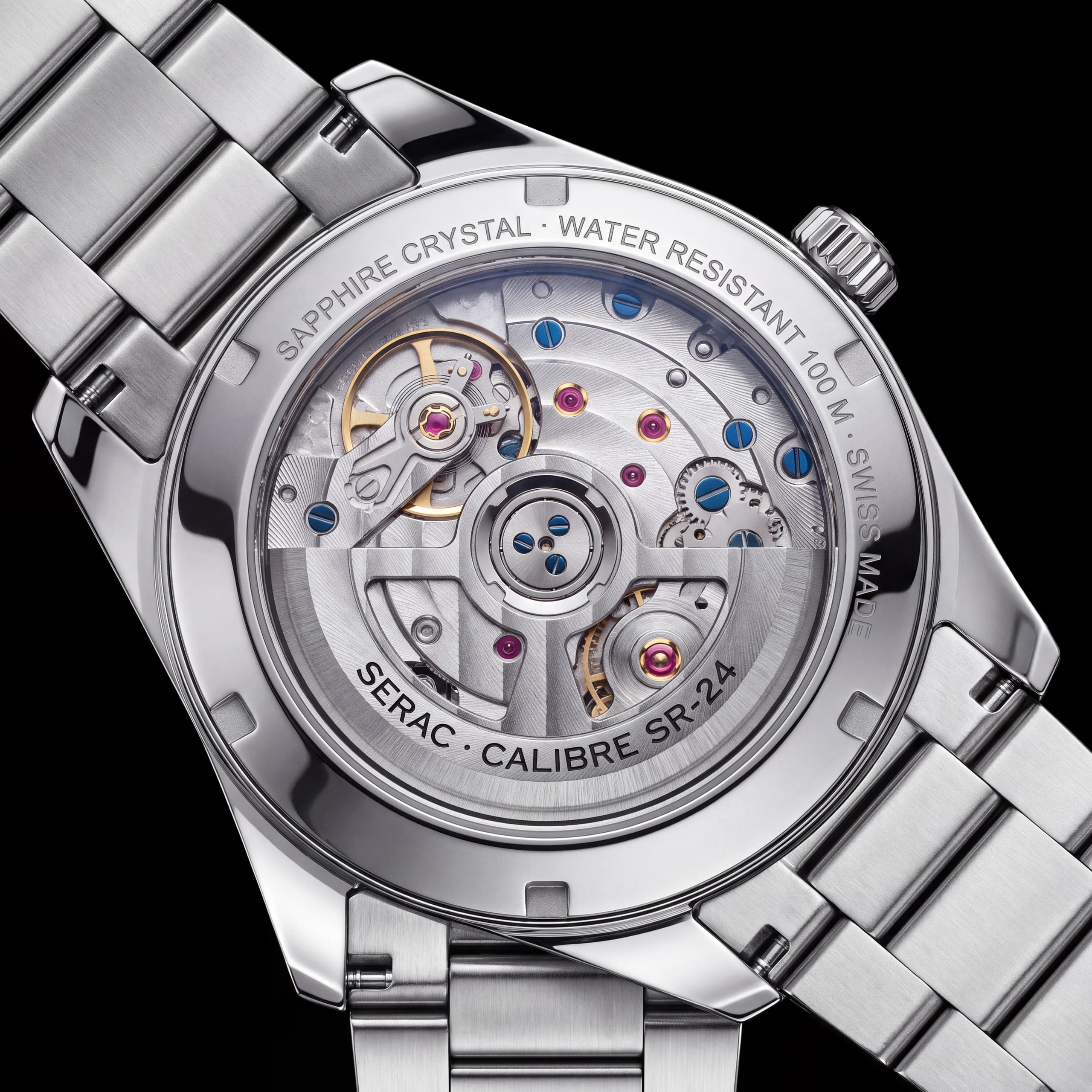 The sapphire exhibition caseback: calibre SR-24 inside a ring engraved Sapphire Crystal, Water Resistant 100 M, Swiss Made.