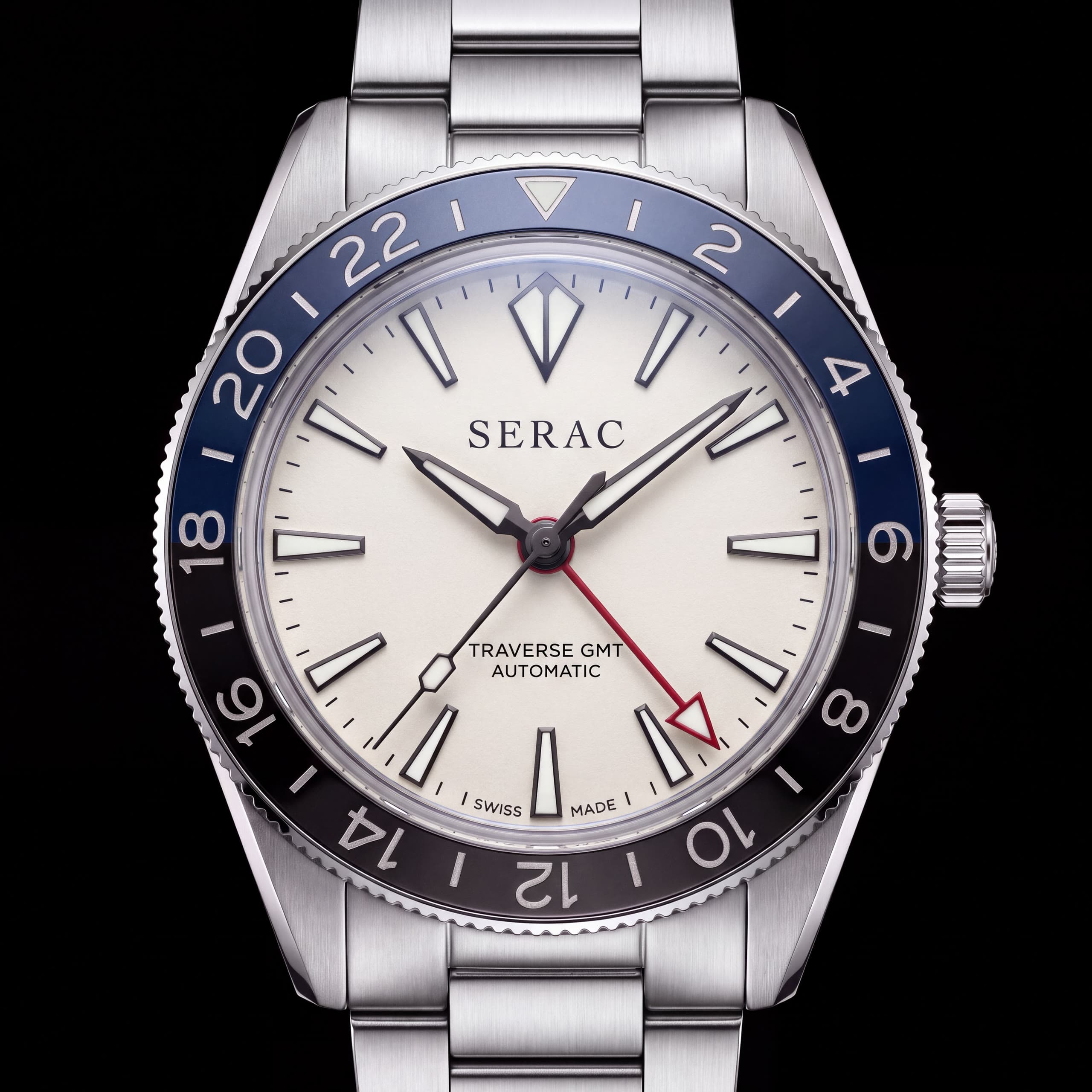 Traverse GMT Névé from the front: glacier blue / obsidian ceramic bezel, ivory grained lacquer dial, steel bracelet.